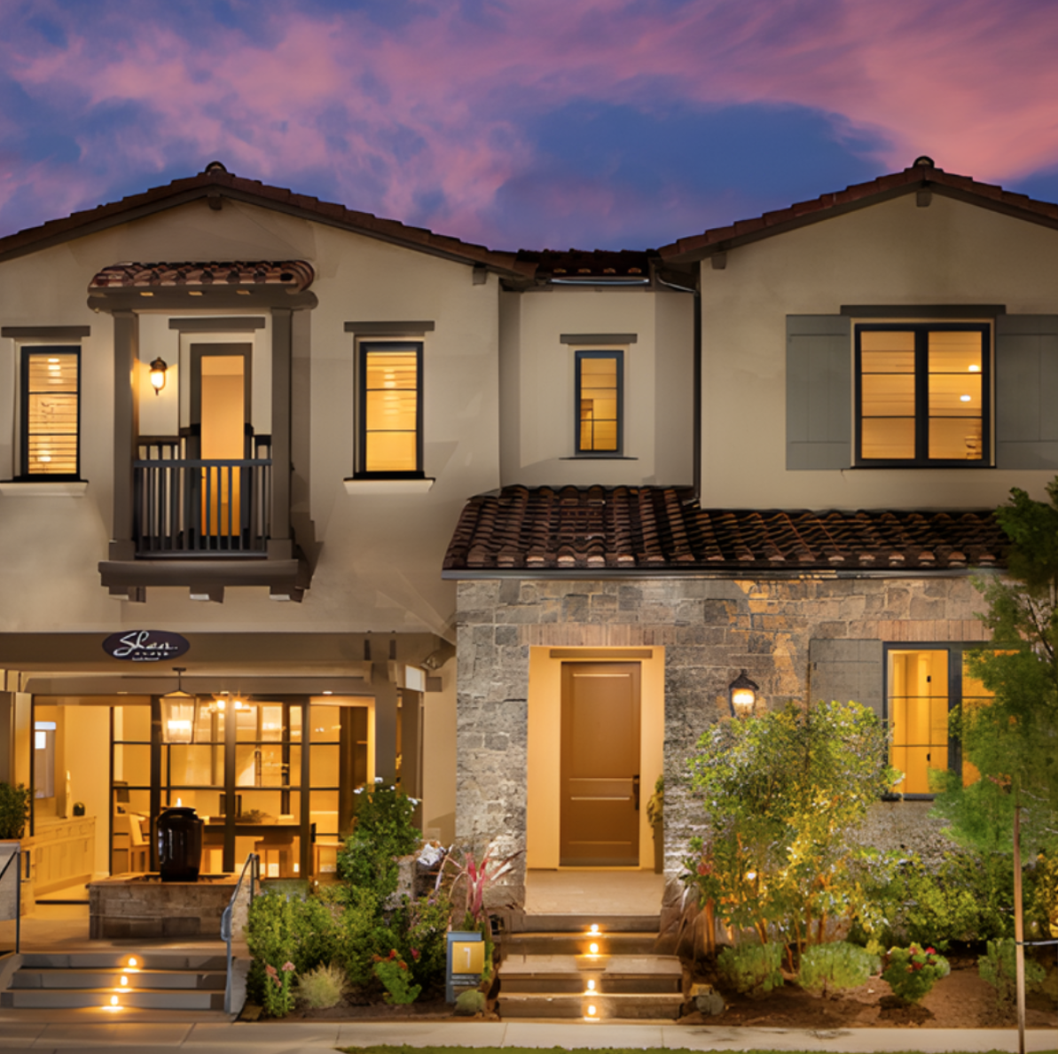 Single family residence with stone masonry at dusk